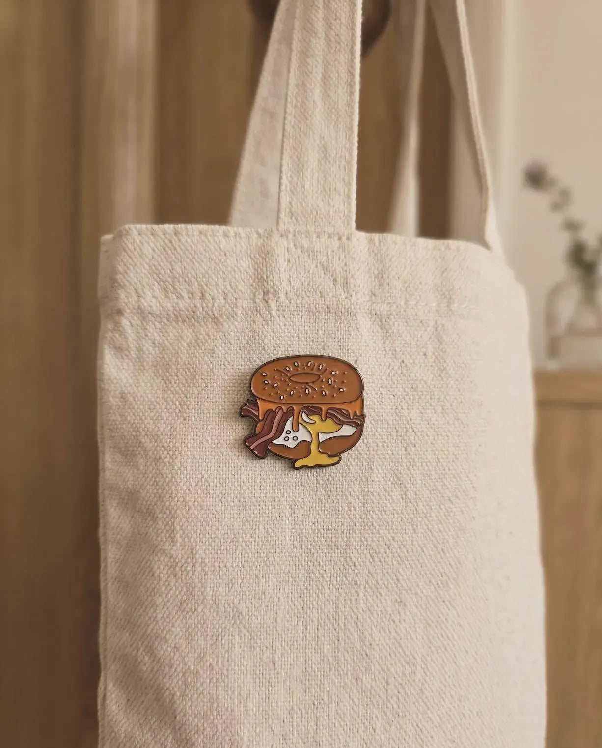 Elevate your accessory game with the ultimate breakfast staple! This Bacon, Egg, and Cheese Bagel Enamel Pin is a must-have for every brunch enthusiast, bagel lover, and foodie collector. Featuring a perfectly rendered "everything" bagel overflowing with crispy bacon, a golden over-easy egg, and melted cheese, this pin looks good enough to eat.Bacon Egg and Cheese Bagel Enamel Pin - Cute Breakfast Foodie Lapel Pin, Everything Bagel Jewelry, Gourmet Food Gift for Chef & Brunch Lover